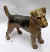 A Bing & Grondahl Copenhagen Model of a terrier, decorated in brown and charcoal, 8 ½” long