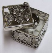 An unusual 20th Century Cuboid Small Inkwell with peony detailed sliding top, pierced floral and