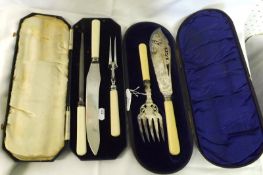 A cased early 20th Century pair of Fish Servers with engraved and pierced blades, bone handles;