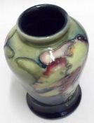 A small Moorcroft Baluster Vase, decorated in Orchid pattern, 4” high (extensive crazing to body)