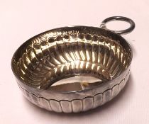 An Elizabeth II Wine Taster, circular shaped with fluted decoration, attached ringlet handle, 3”