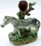 A 19th Century Staffordshire Spill Vase, modelled as a horse resting against a tree trunk, decorated