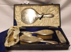 A George V cased Five Piece Silver Backed Dressing Table Set, comprising Hand Mirror, two