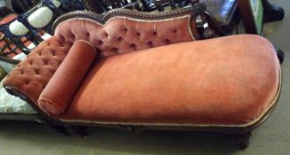 A Victorian Mahogany Chaise Longue, the chevron moulded arched back terminating in ring turned and