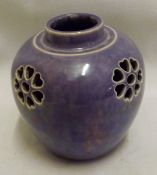 A Ruskin small squat Vase, with pierced floral design to shoulders, finished in a purple