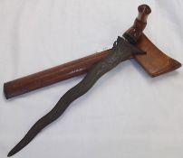 A Malayan Kris, wavy blade 14”, carved wooden grip in the form of a Garuda Bird, wooden sheath