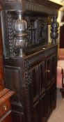 A large 19th Century Oak Court Cupboard, the top with two heavy doors with arched detail, the base