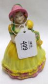 W H Goss Figurine “Peggy” decorated in yellow, pink and greens, 5” high