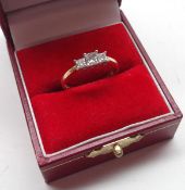 A high grade precious metal Ring set with three princess cut Diamonds (approximately .5 ct total)