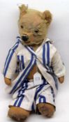 An early 20th Century Teddy Bear, attributed to Chiltern, blonde mohair covered with swivel head,