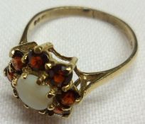 A hallmarked 9ct Gold centre small circular Opal and eight Garnet surround Cluster Ring