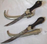 Pair Moroccan Jambiyas, metal mounted wooden grips, metal scabbards (2)