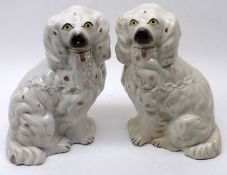 A small pair of 19th Century Staffordshire Model spaniels, of typical form, decorated in colours