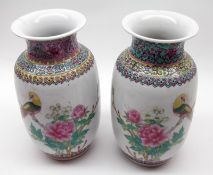 A pair of 20th Century Oriental Baluster Vases, brightly painted in colours with parrots and foliage