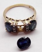 A high grade precious metal three oval Dark Blue Sapphire and six small brilliant cut Diamond