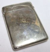 A George V Card Case of plain rectangular form, engraved with an elaborate monogram to the front,
