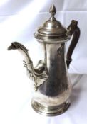 A George III period Coffee Pot of circular baluster form, to a circular foot, acanthus clad spout,