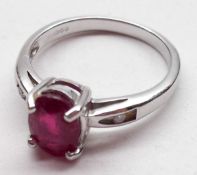 A hallmarked 9ct Gold centre oval Ruby Ring with a small Diamond to each shoulder, the ruby