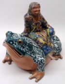 An unusual Oriental Container formed as a toad with a figure seated on his back (figure forms the
