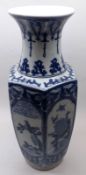 A modern Oriental Baluster Vase of hexagonal form, decorated in underglaze blue with panels of