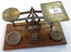 A Set of Vintage Brass Postal Scales and Weights on an Oak Base, 7 ½” long