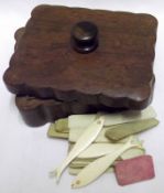A small Mahogany Box containing a collection of various assorted bone gaming counters