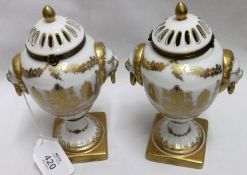 A pair of modern Covered Urns by Chelsea House with pierced lids, decorated with gilt design and