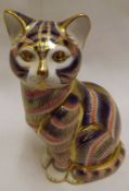 A Royal Crown Derby Paperweight, modelled as a sitting tabby cat, decorated in red, blue and gold,