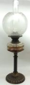 A Victorian Oil Lamp with clear glass chimney, frosted glass shade with floral decoration, brass