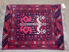 An Afghan Prayer Mat, central geometric pattern, mainly red field, .75m x .6m