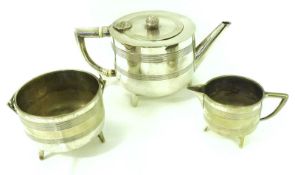 An early 20th Century Modernist Three Piece Tea Set of cylindrical form with reeded body bands, each