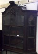 An Oak Glazed Fronted and Sided Wall Cabinet, crested with rosette mount, 19th Century, 29” wide