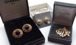 A Mixed Lot comprising: a cased pair of Chanel Gilt Metal Clip On Earrings with purple stone