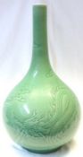 A large Oriental Celadon balustered Spill Vase, possibly Korean, the body decorated with dragons and