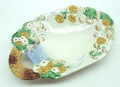 A Clarice Cliff Newport Pottery single handed side Dish, moulded with floral and bridge