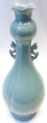 An Oriental Celadon Spill Vase of ribbed tulip baluster form, applied with pierced handles, raised
