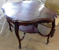 A late Victorian shaped oval Mahogany two tier centre Table, raised on four cabriole legs, with