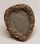 A small late Victorian Silver mounted Photograph Frame, heart shaped with shell and foliate embossed