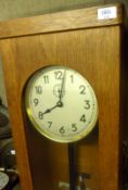 A mid 20th Century Master or Slave Clock in light Oak Case with glazed front, circular face with