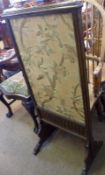 A Victorian Oak adjustable Screen of rectangular form, with a foliate Wool embroidered sliding