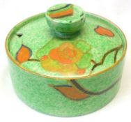 A Clarice Cliff circular covered Preserve Pot of compressed form, decorated with a sinuous floral