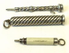 A wrythen fluted white metal Pencil Holder; a hallmarked Silver Propelling Pencil; and a further