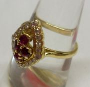 An unmarked high grade yellow metal marquise design Ring set to the centre with four small Rubies