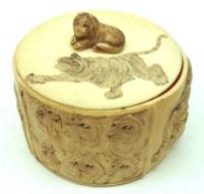 A carved Ivory oval lidded Box with pull-off cover, the lid decorated with a motif of a Tiger,