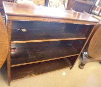 An Edwardian open front Mahogany Bookcase, the cross banded top to a frieze inlaid with floral