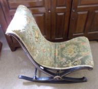 A Victorian low Rocking or Nursing Chair, on “X” shaped Ebonised and Gilt painted frame, 30” high.