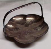 A Far Eastern white metal lobbed sided Dish, the centre engraved with prunus and bamboo design,