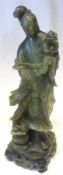 A large Oriental Jade or Jadeite Figure of a Young Girl clutching a sprig of Foliage, 20th Century,