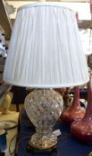 A 20th Century Table Lamp, the shaped metal base to a heavy cut glass vase shaped stem, fitted