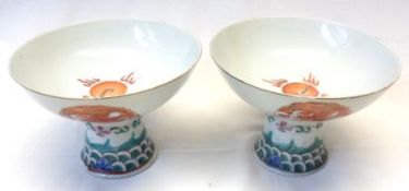 A pair of Oriental large circular stemmed Goblets or Cups, painted in the Kutani manner with
